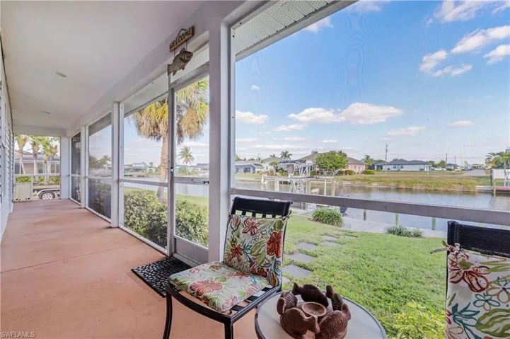 Sunroom featuring a residential view and a water view