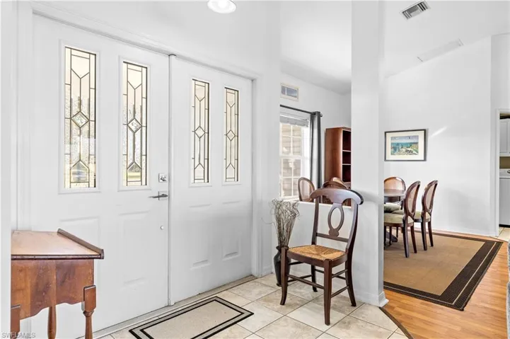 Foyer with light tile patterned flooring and washer / dryer