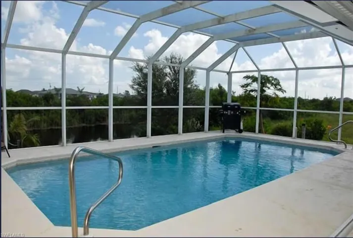 Outdoor pool featuring a lanai and a patio