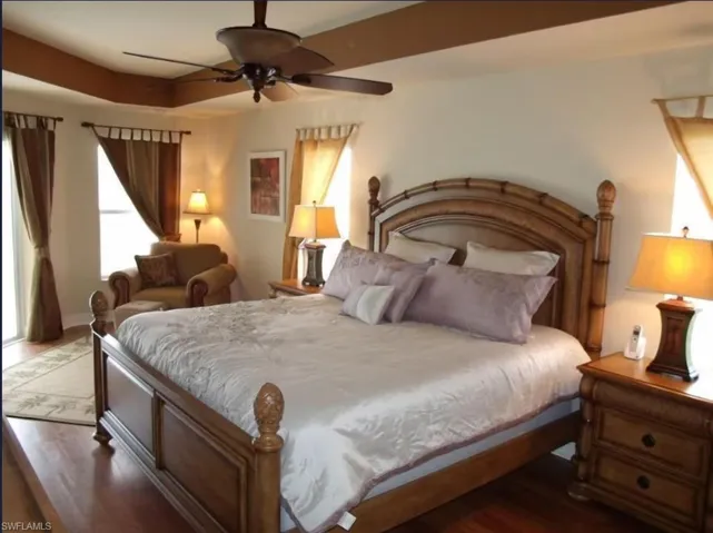 Bedroom with a ceiling fan and wood finished floors