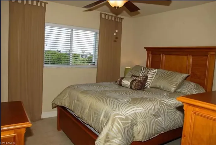 Bedroom featuring light carpet and ceiling fan