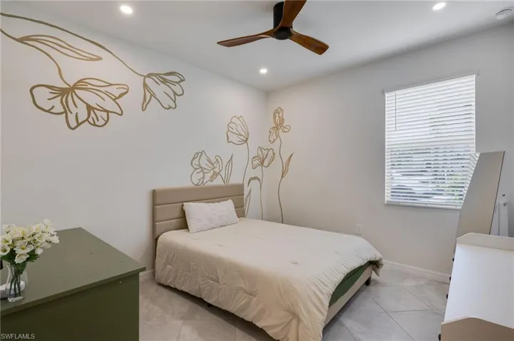 Bedroom featuring light-toned tile flooring, recessed lighting, and a ceiling fan