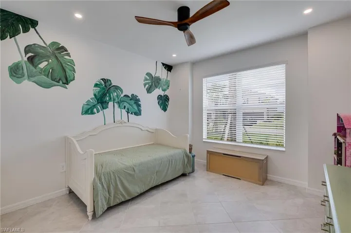 White walls with integrated recessed lighting and a ceiling fan
