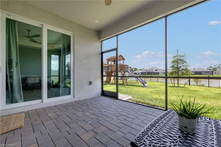 Screened patio featuring paver flooring and sliding glass doors