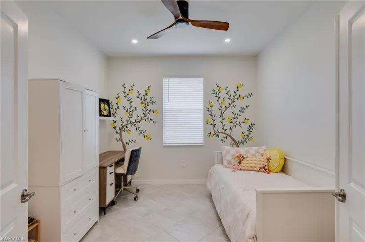 Bright room featuring recessed lighting, a ceiling fan with wood-finish blades, and tile flooring