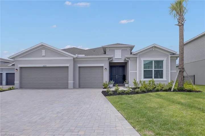 Contemporary single-story residence with a gray stucco and siding exterior, featuring a double-door entry