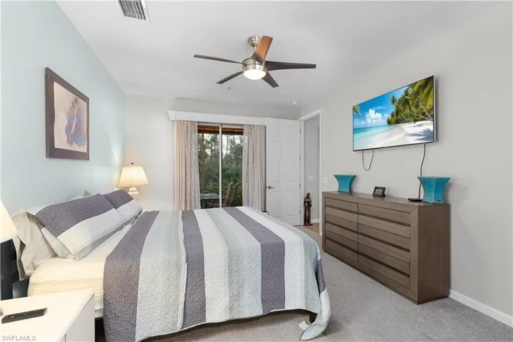 Bedroom with light carpet, access to outside, and ceiling fan