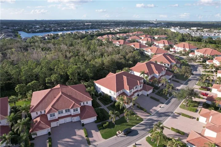 Birds eye view of property with a water view