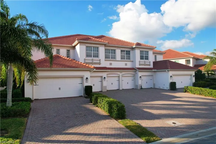 Mediterranean / spanish home with central AC unit and a garage