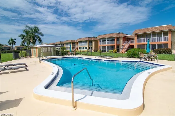 Resort-style swimming pool featuring integrated steps and a surrounding sun deck