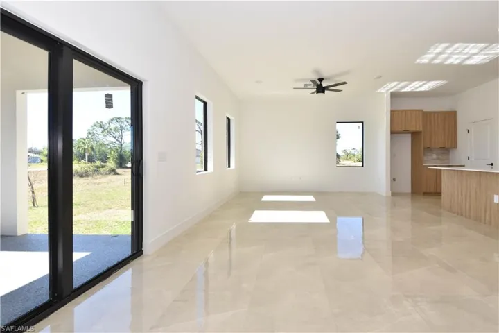 Unfurnished living room featuring ceiling fan