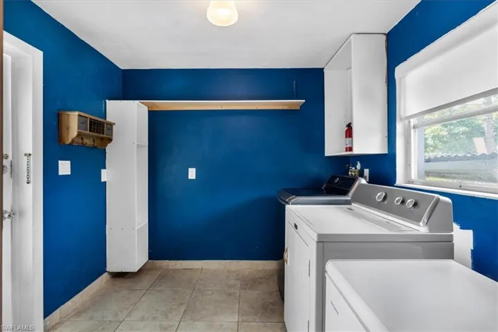 Tiled flooring with an exterior window and built-in shelving