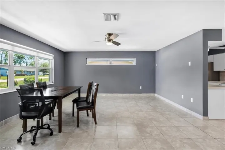 Tile flooring throughout, with a large window and an additional horizontal window