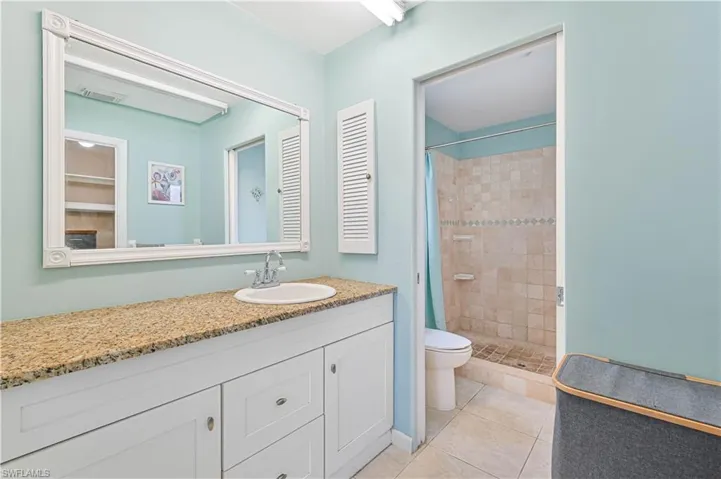 Bathroom featuring vanity, a stall shower, and light tile patterned floors