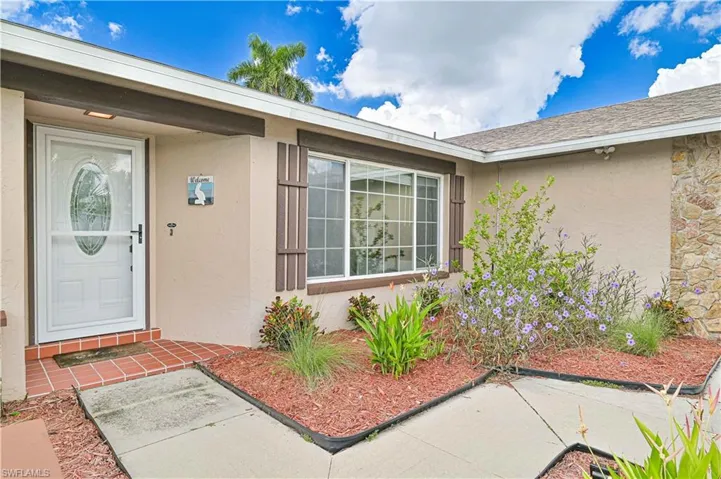 Property entrance featuring stucco siding