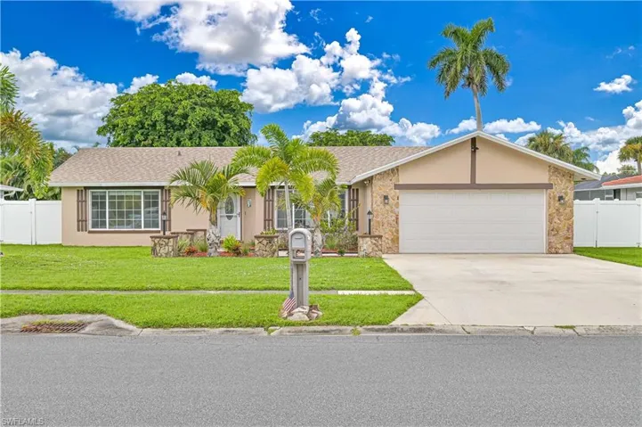 Single story home with stucco siding, concrete driveway, a shingled roof, stone siding, and a garage