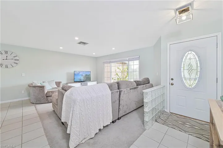 Entrance foyer featuring light tile patterned flooring and recessed lighting