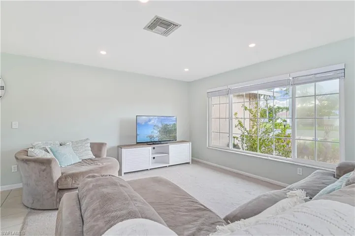 Living area with baseboards and recessed lighting