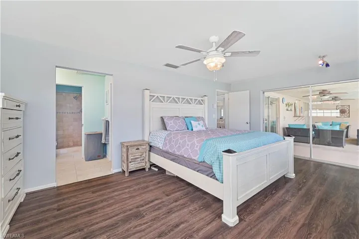Bedroom with a ceiling fan and dark wood-style floors