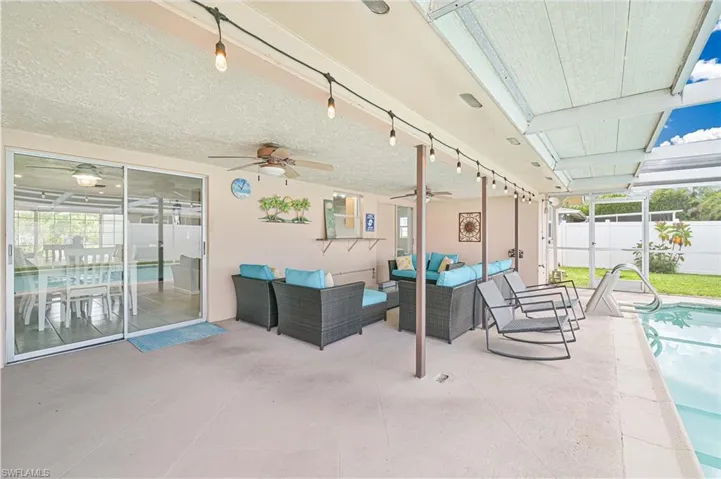 View of patio / terrace with outdoor lounge area, a ceiling fan, and a sunroom