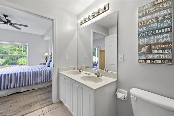 Light and bright bathroom serving primary bedroom