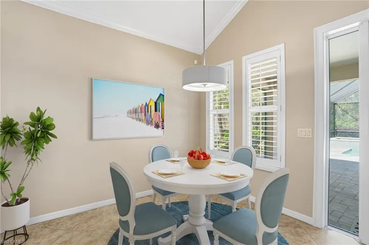 Dining room featuring ornamental molding and light tile patterned floors