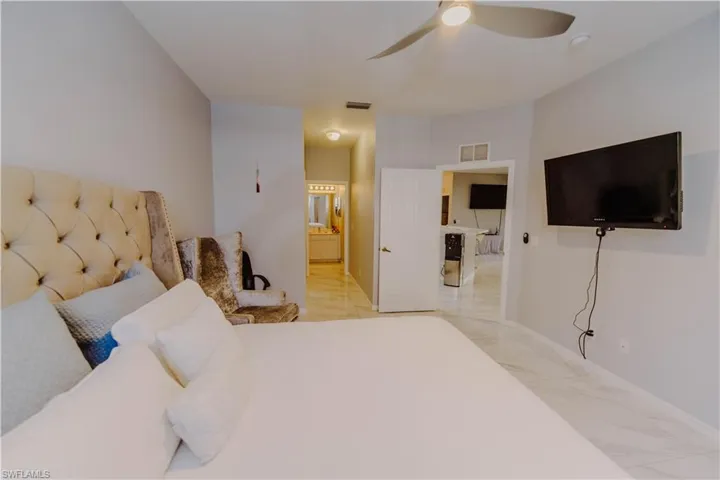 Bedroom with ensuite bath and ceiling fan