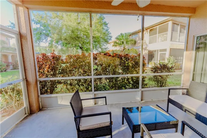 Sunroom with outdoor lounge area and ceiling fan