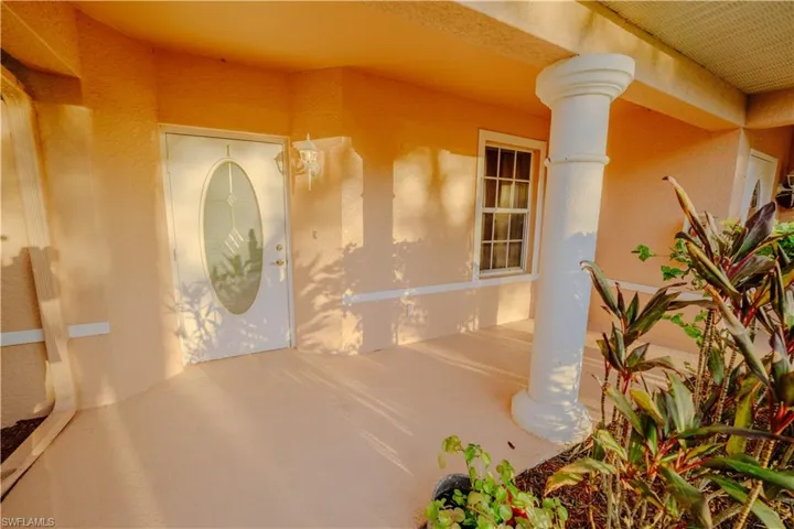 Entrance to property featuring stucco siding and a porch