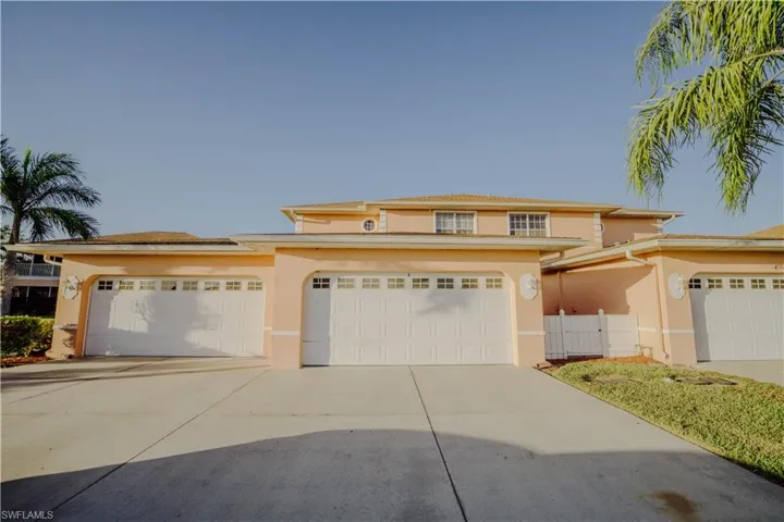 View of front of house featuring stucco siding, concrete driveway, and an attached garage