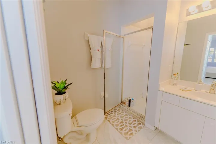 Bathroom with a stall shower and vanity
