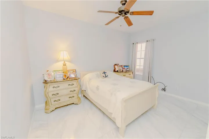 Bedroom with baseboards and ceiling fan