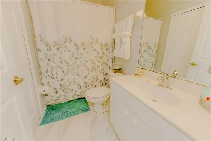 Full bathroom featuring vanity and curtained shower