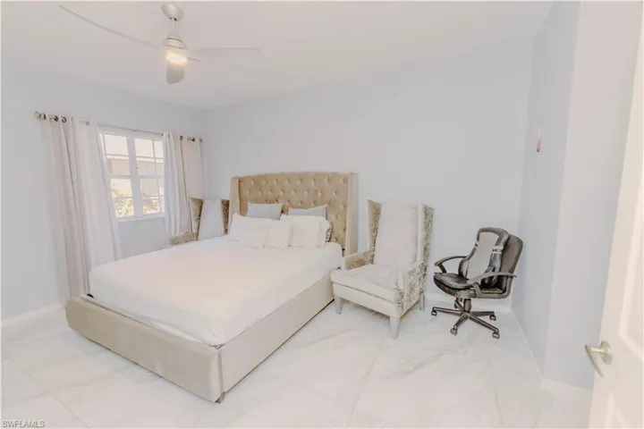 Bedroom with ceiling fan and baseboards