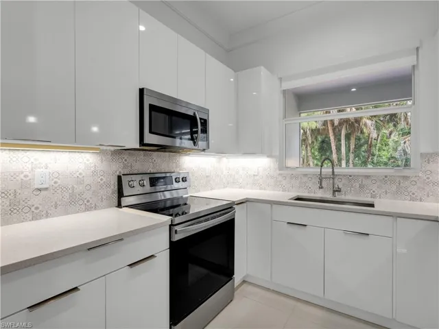 Kitchen with appliances and  under cabinet lighting