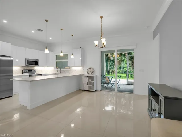 Dining Area with large tile flooring and lighting fixture