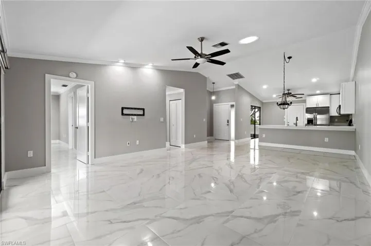 Unfurnished living room with crown molding, a ceiling fan, and recessed lighting