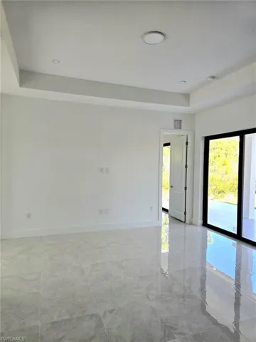Entrance to property with stucco siding and a yard