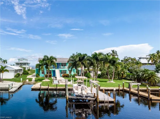 View of dock featuring a lawn and a water view