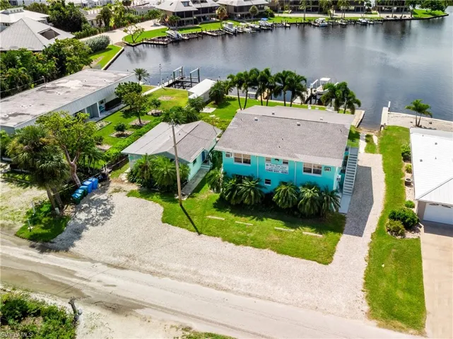 Birds eye view of property with a water view