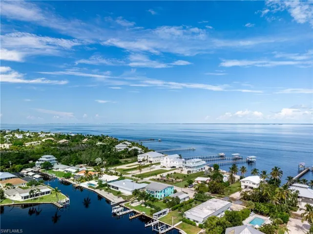 Birds eye view of property with a water view