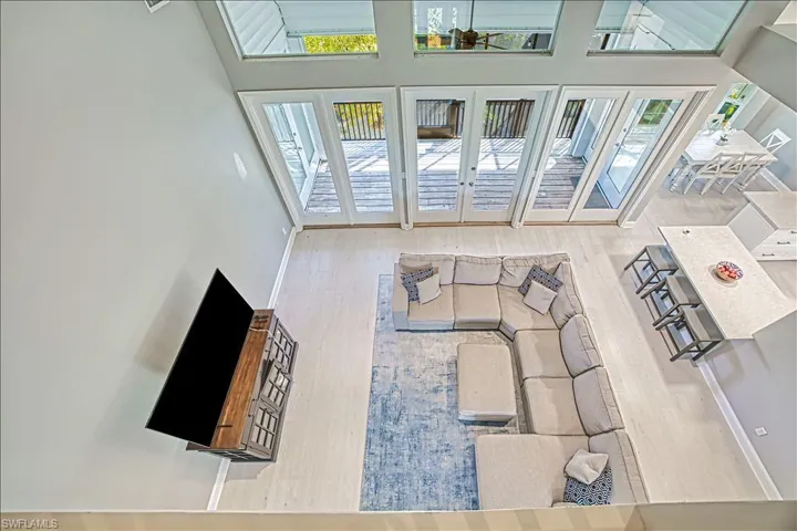 Living room featuring a towering ceiling and hardwood / wood-style floors