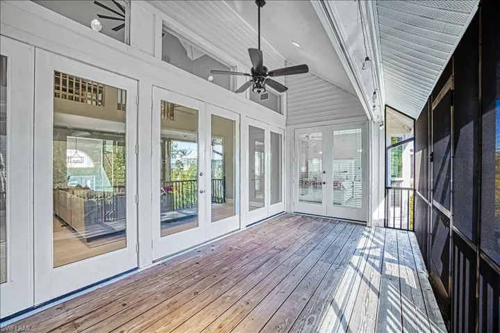 Unfurnished sunroom with lofted ceiling with beams and ceiling fan
