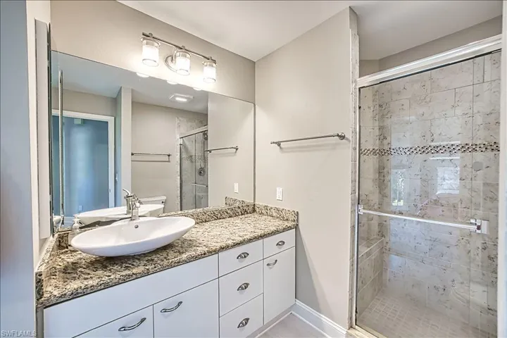 Bathroom featuring vanity and walk in shower