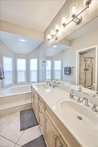 Full bathroom featuring tile patterned flooring, vanity, plus walk in shower, and toilet
