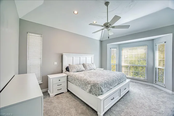 Carpeted bedroom featuring ceiling fan