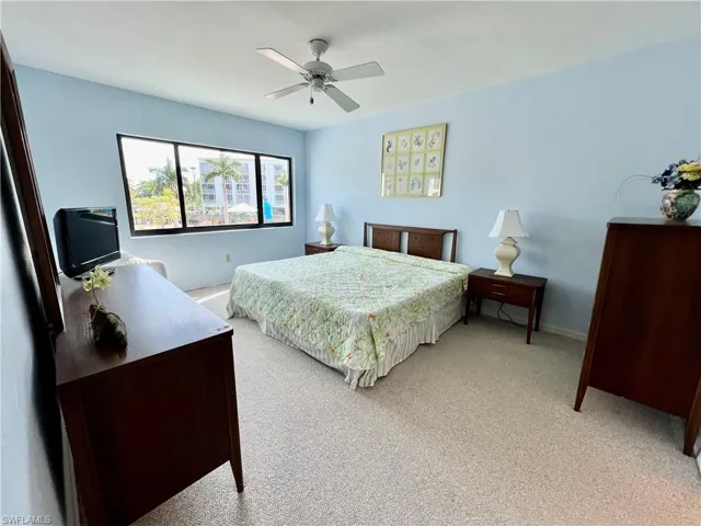 Bedroom featuring light carpet and ceiling fan