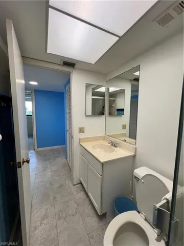 Bathroom with tile patterned floors, toilet, and vanity