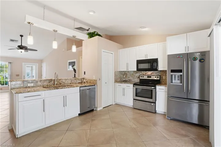 White cabinetry with Stainless Steel Appliances