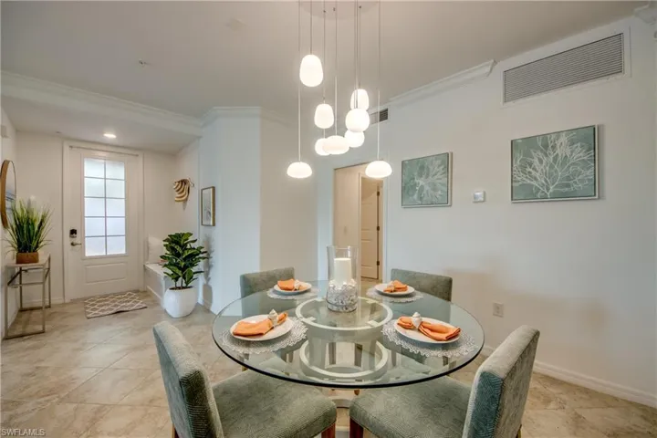 Tiled dining room with crown molding